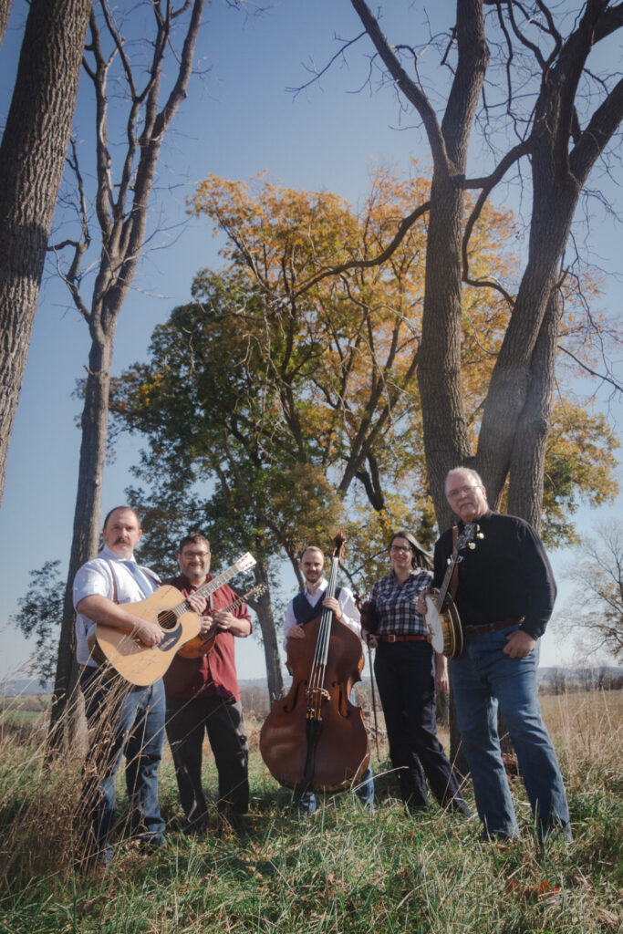 Shade Tree Collective posing outdoors beneath a tree with fall foliage